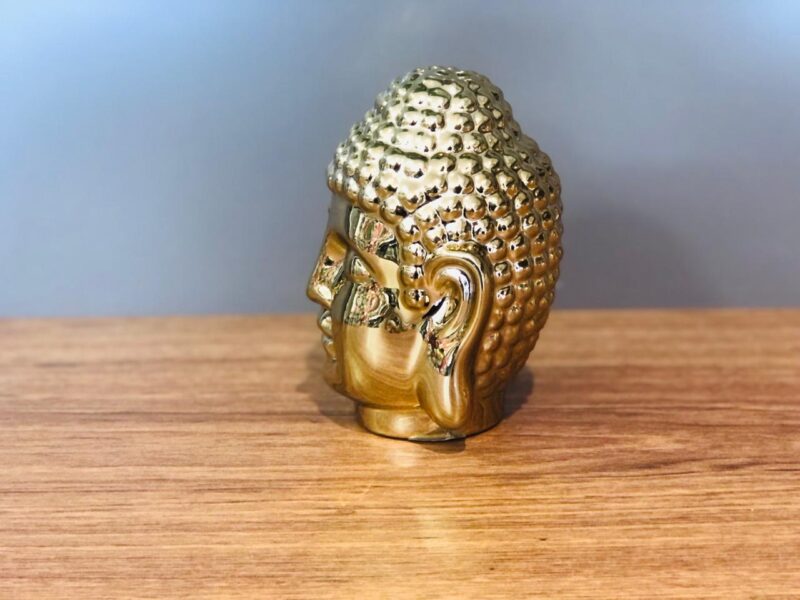 Escultura cabeça Buda na cor dourada